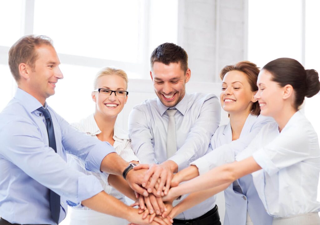 Team members joining hands